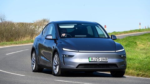 Tesla Model Y (2025) review: front three quarter driving, close up, silver paint