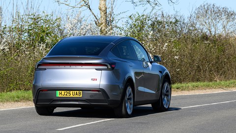 Tesla Model Y (2025) review: rear three quarter driving, silver paint