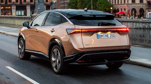 Nissan Ariya electric SUV review, rear view, driving in city