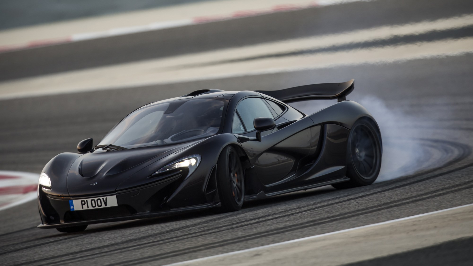 McLaren P1 review, Bahrain, black, front view, oversteer, tyres smoking
