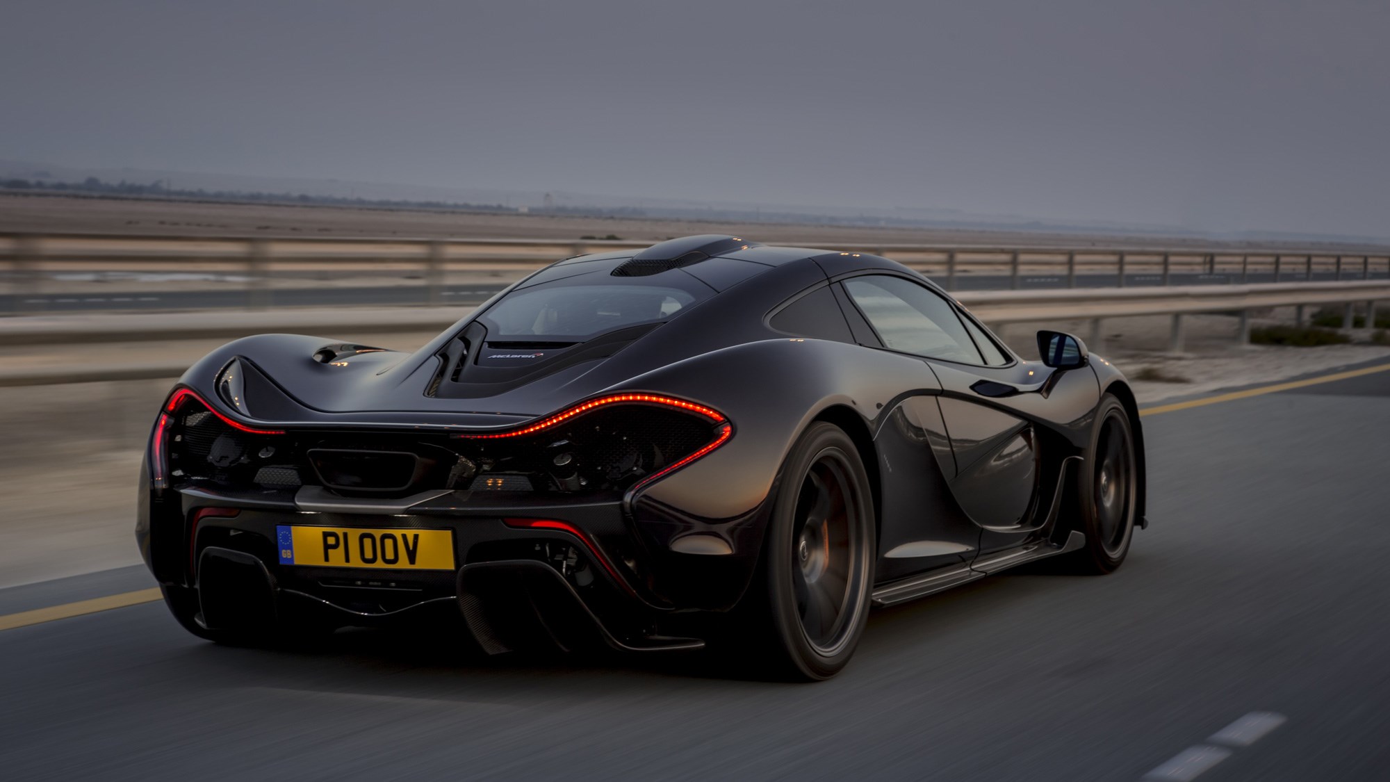 McLaren P1 review, Bahrain, black, rear view, driving on the road