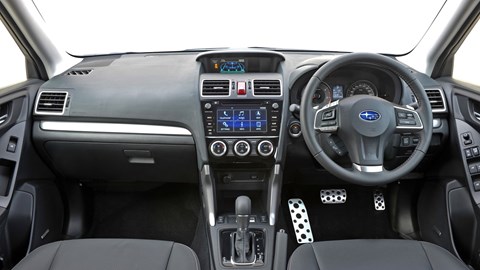 Brighter bits of metallic trim and gloss black console brighten up the drab interior a little