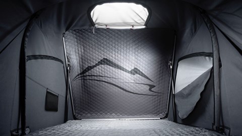 Inside the Porsche 911 rooftop tent: quilted headboards and integrated mattress