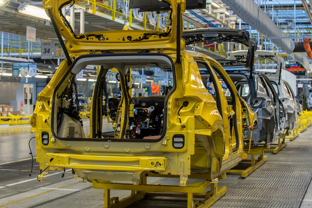 Jeep Avenger: body shell rolling down production line, rear three quarter, yellow paint