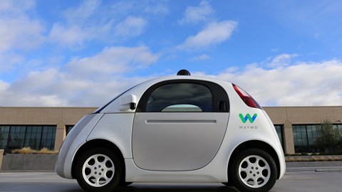Side view of Waymo custom-built Firefly vehicle, has no steering wheel or pedals