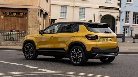 Jeep Avenger (2023) review: rear three quarter driving, yellow paint, town centre
