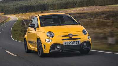 Abarth 595 (2022) review: front three quarter driving, yellow car, rural background