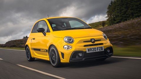 Abarth 595 (2022) review: hero front three quarter driving, yellow car, rural background