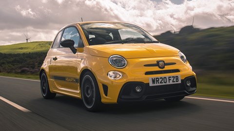Abarth 595 (2022) review: close-up front three quarter driving, yellow car, rural background