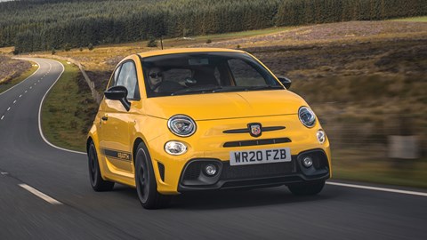 Abarth 595 (2022) review: front three quarter driving, yellow car, rural background