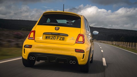 Abarth 595 (2022) review: close-up rear view driving, yellow car, rural background