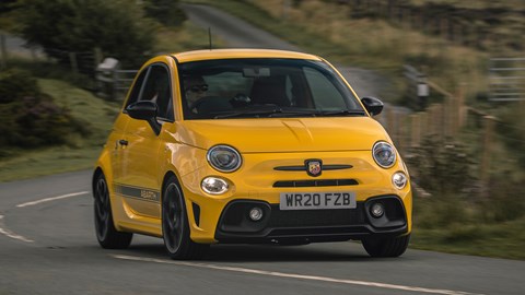 Abarth 595 (2022) review: front view cornering, yellow car, rural background