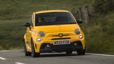 Abarth 595 (2022) review: front three quarter cornering, yellow car, rural background
