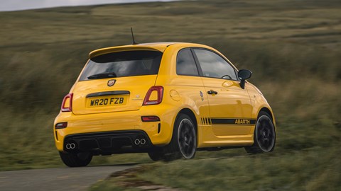 Abarth 595 (2022) review: three three quarter cornering, yellow car, rural background