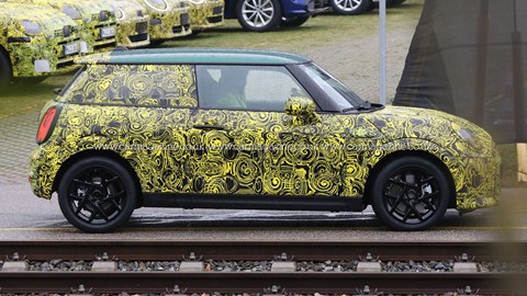 2023 Mini hatchback spy photos - side view, yellow camo, green roof, black wheels
