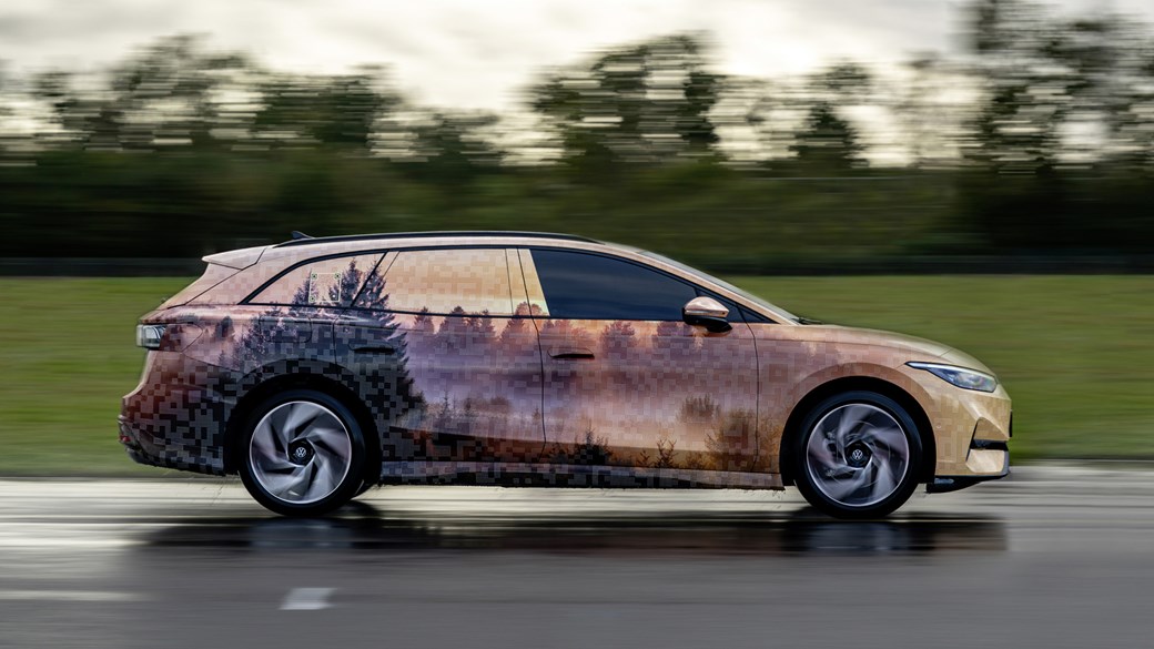 Volkswagen ID.7 Tourer, pan shot driving, wearing camouflage wrap