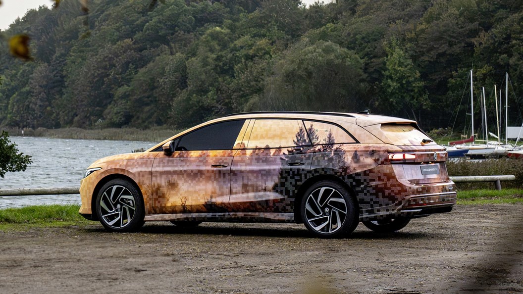 Volkswagen ID.7 Tourer, rear three quarter static, wearing camouflage wrap