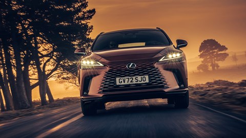 Lexus RX 450h+ review: front tracking shot, bronze car, sunset road