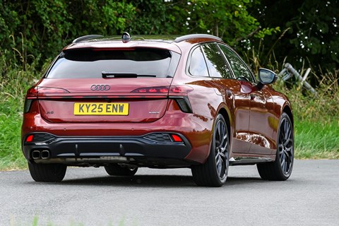 Image of a red Audi A6 Avant driving round a right-hand corner, viewed from the rear