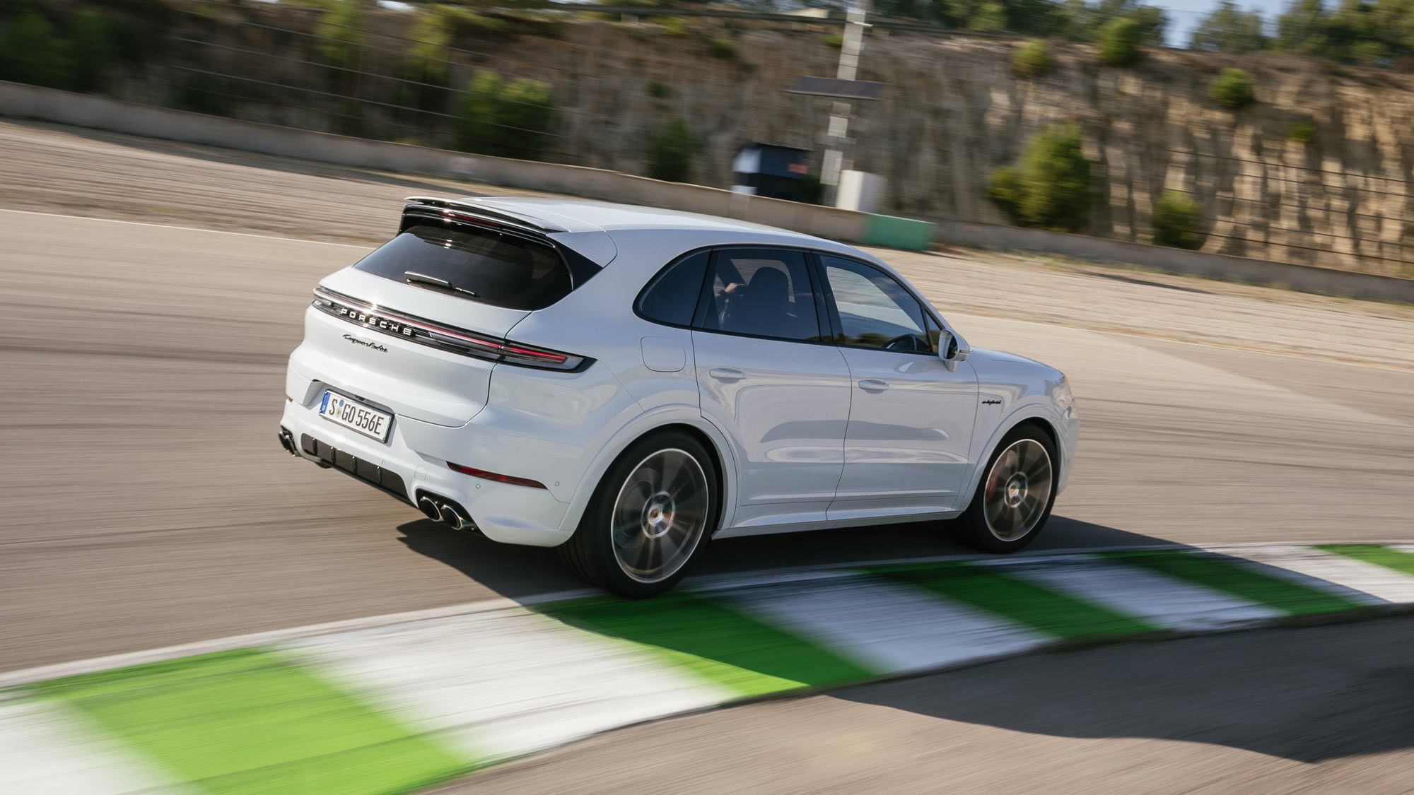 Porsche Cayenne E-Hybrid review - 2023-facelift - Turbo E-Hybrid, white, rear, driving round corner on racing circuit