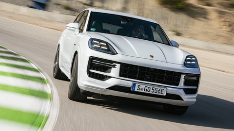 Porsche Cayenne E-Hybrid review - 2023-facelift - Turbo E-Hybrid, white, front, driving round corner on racing circuit