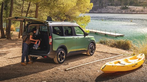 Ford Tourneo Courier rear three quarter static, next to a lake, green paint