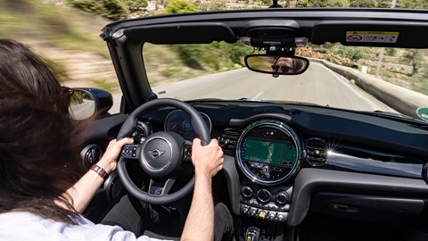 MINI Electric Convertible (2023): over-the-shoulder driving shot, black car, Mallorca road