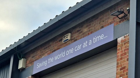 Sign at the Electrogenic workshop that reads 'Saving the world one car at a time...' - Bauer Media exclusive image