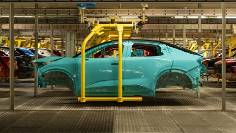 Side view of blue Nissan Leaf body on factory line in the UK