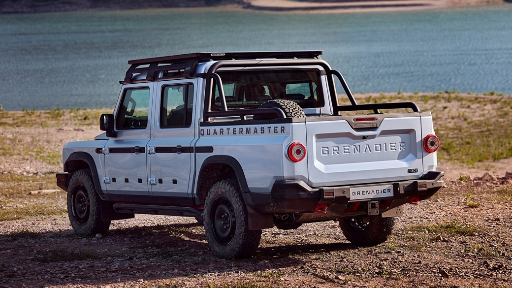 Ineos Quartermaster: rear three quarter static, silver paint, parked in front of a lake