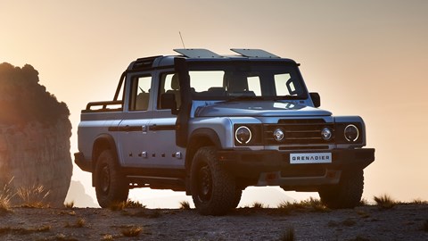 Ineos Quartermaster: front three quarter static, silver paint, atop a mountain, sunset