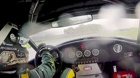 Giedo van de Garde at the wheel of a laity Cobra on a wet Goodwood circuit