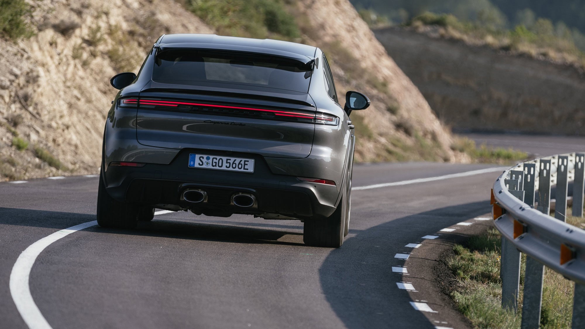 Porsche Cayenne Coupe review - 2023 facelift - Turbo E-Hybrid with GT Package, grey, rear, driving through corners