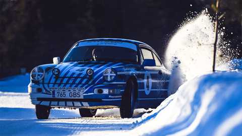 Air-cooled Porsche 911 ice-driving experiences available in Lapland, blue 911 drifting into snow bank, snow flying