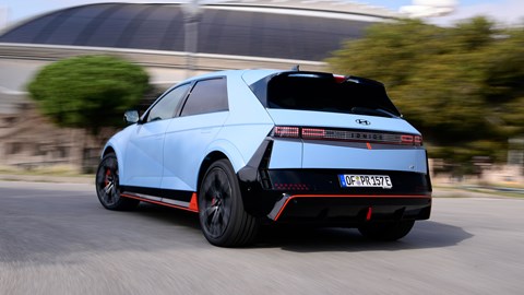 Hyundai Ioniq 5 N (2024) review: rear three quarter driving, blue paint, Spanish roads