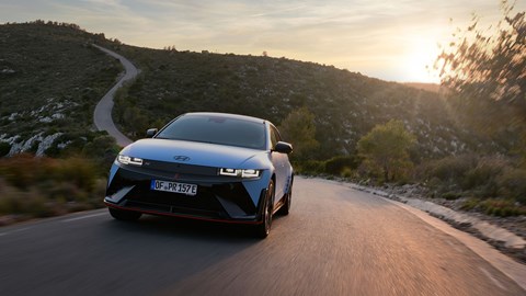 Hyundai Ioniq 5 N (2024) review: front three quarter driving, sunset shot, blue paint, Spanish roads