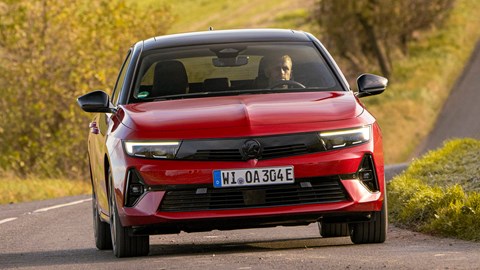 Vauxhall Astra Sports Tourer Electric (2023) review: front three quarter cornering, British country lane, red paint