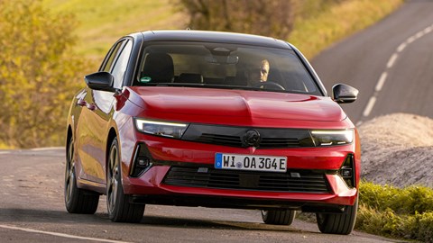 Vauxhall Astra Sports Tourer Electric (2023) review: front three quarter cornering, low angle, British country lane, red paint