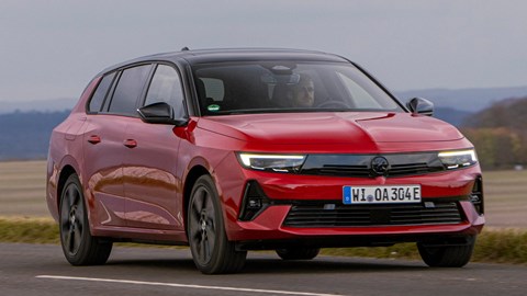 Vauxhall Astra Sports Tourer Electric (2023) review: front three quarter cornering, close-up, British country lane, red paint