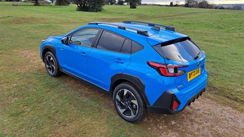 Subaru Crosstrek: rear three quarter static, blue paint, in a field