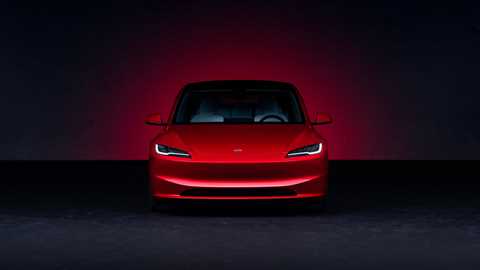 Tesla Model 3 facelift: front view, red paint, studio shoot