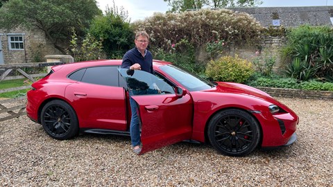 Man getting into Porsche Taycan estate