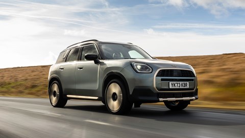 MINI Countryman (2024) review: front three-quarter driving, low angle, British B-road, silver and gold paint