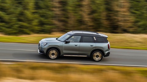 MINI Countryman (2024) review: side view driving, high angle, British B-road, silver and gold paint