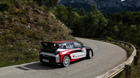 Image of the Lancia Ypsilon Rally2 HF Integrale, viewed from the rear, going round a left-hand corner
