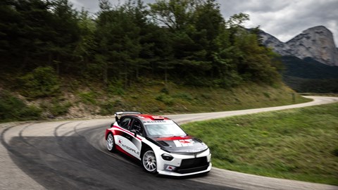 Image of the Lancia Ypsilon Rally2 HF Integrale, viewed from the side, going round a left-hand corner