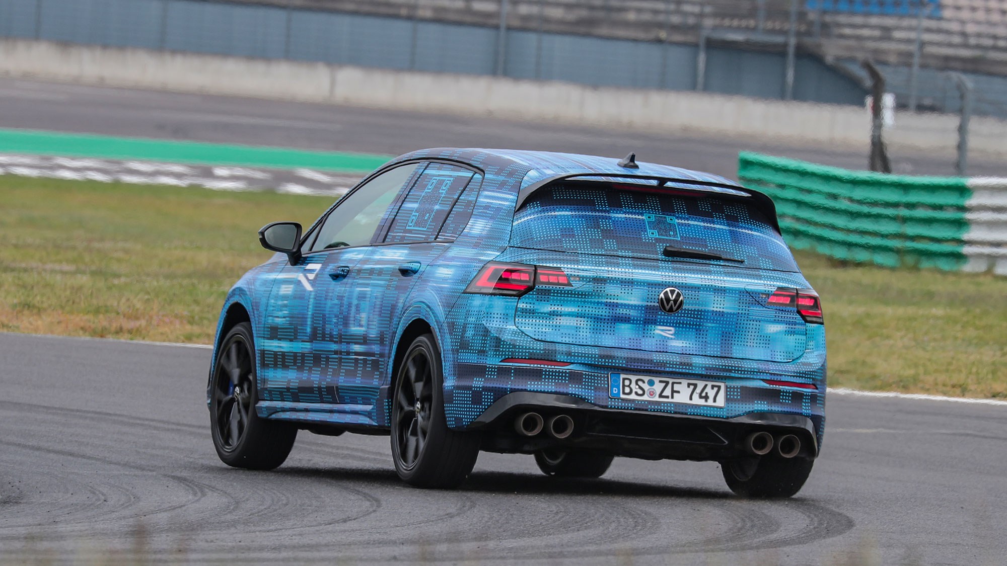 Volkswagen Golf R prototype review: rear three quarter cornering, on a race track, camo wrap