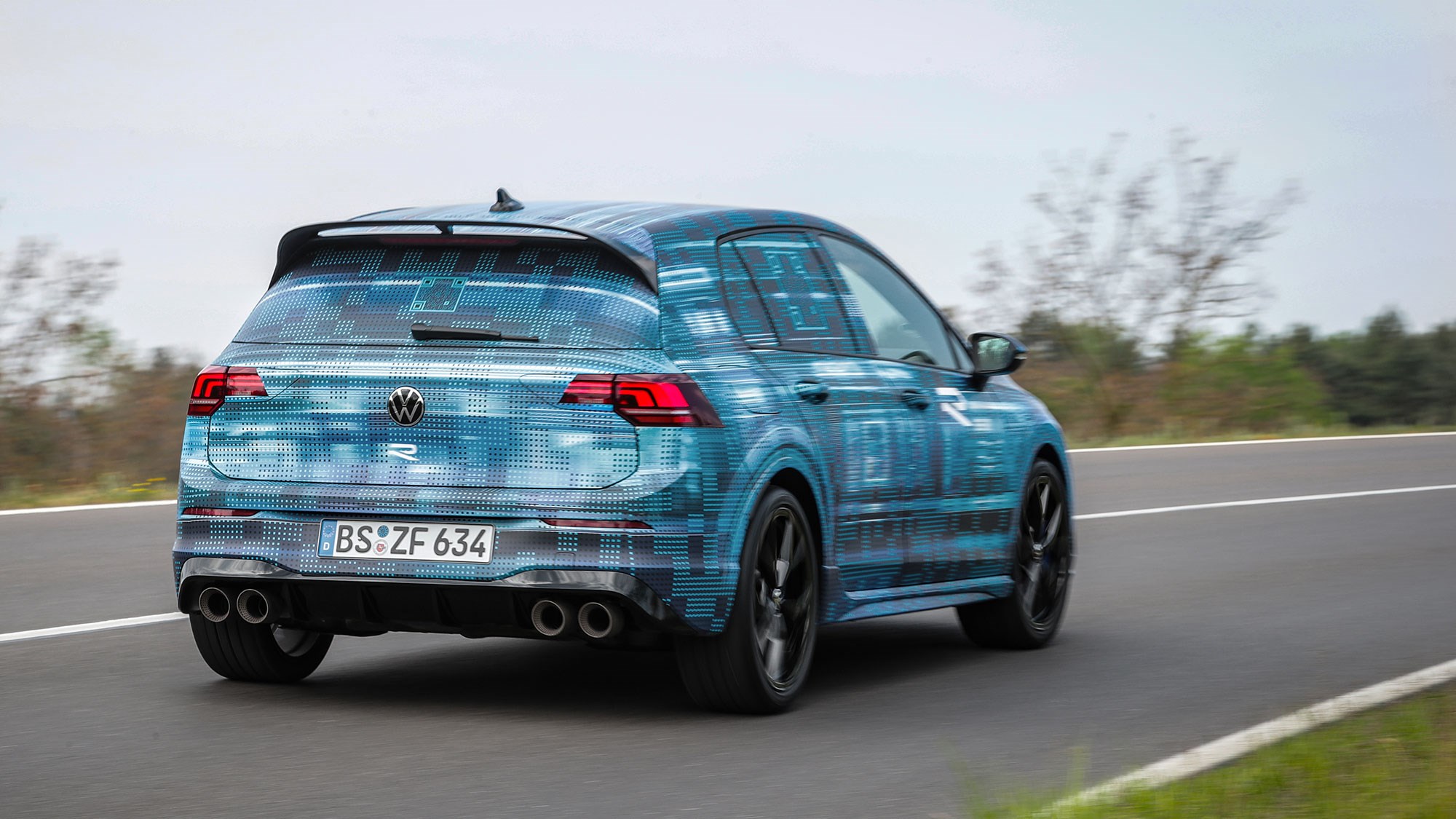 Volkswagen Golf R prototype review: rear three quarter cornering, German country road, camo wrap