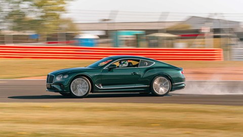 Election manifestos 2024: a green Bentley Continental GT doing a skid on a race track, (representing the Green Party)