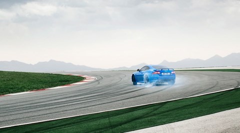 Election manifestos 2024: Jaguar XKR-S doing a skid on a race track, (representing the Reform UK party)